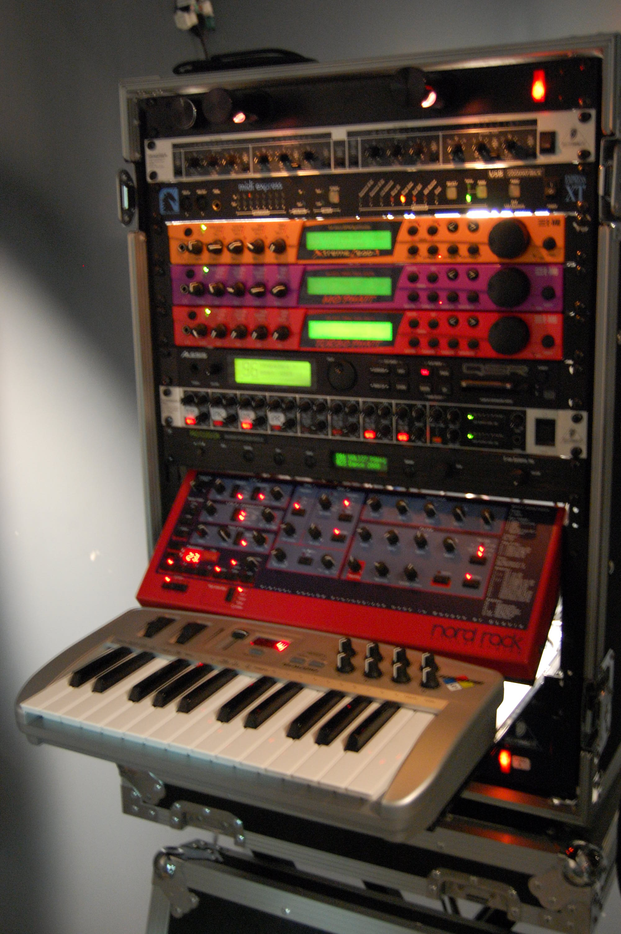 A standard portable audio rack cabinet containing a variety of different audio components, including a small controller keyboard.